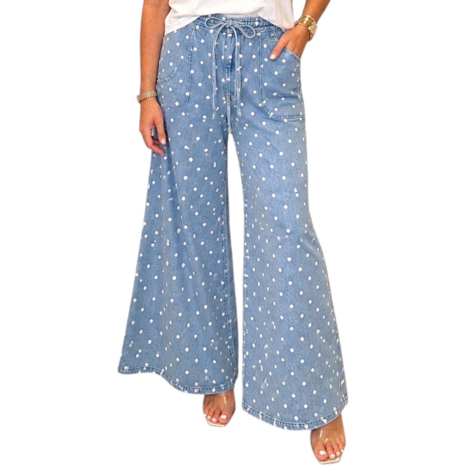 woman wearing light denim polka dot wide leg pants on white background