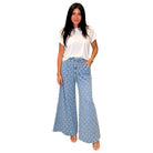 woman wearing light denim polka dot wide leg pants on white background