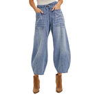 Wide-leg denim pants worn by a person on a white background