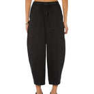 Black wide-leg pants worn by a person on a white background