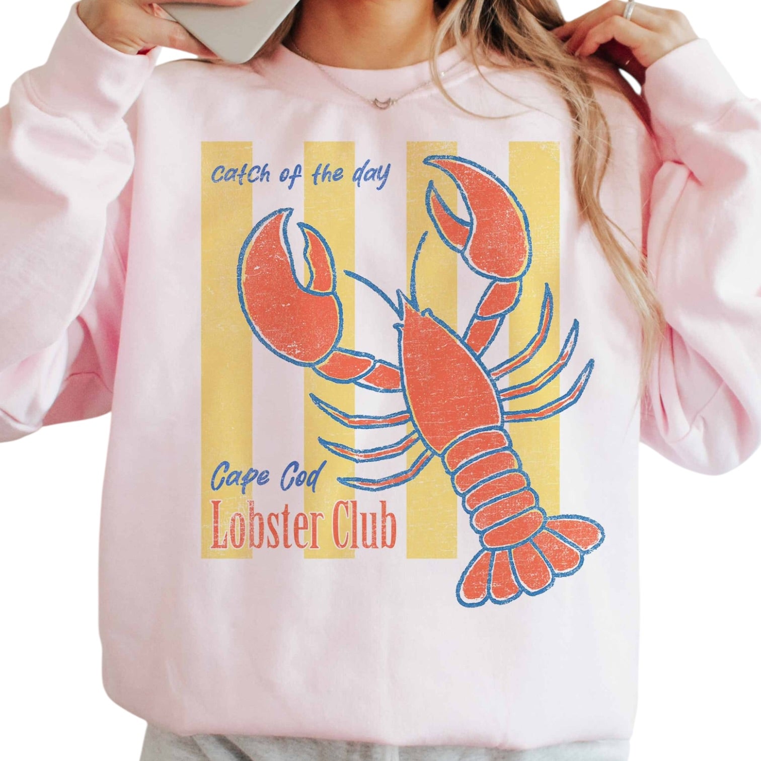 Pink sweatshirt with a lobster graphic and text on a white background