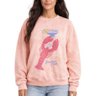 Person wearing a pink sweatshirt with a lobster graphic and 'Dixie's Club' text.