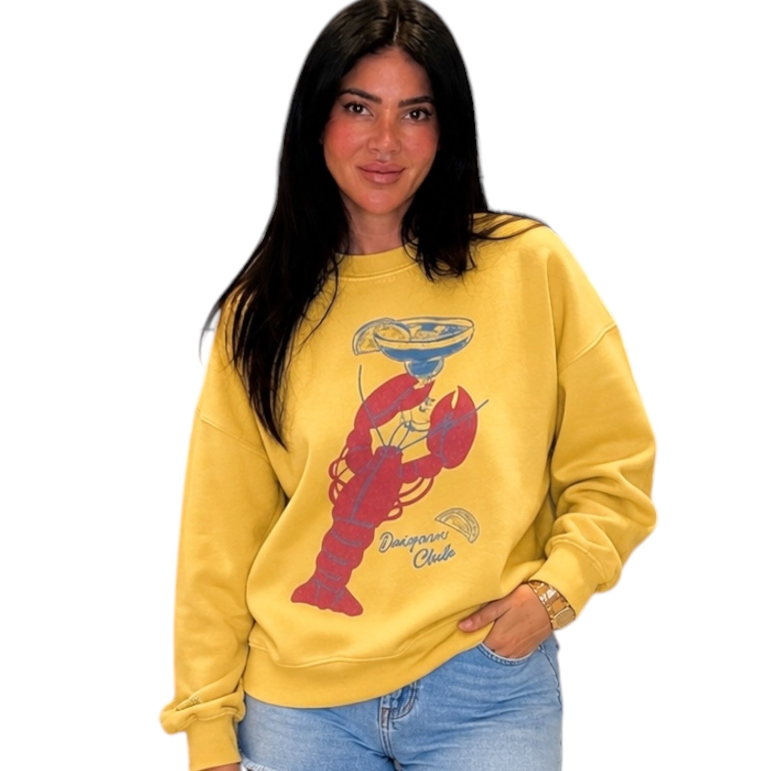 Woman wearing a yellow sweatshirt with a red lobster design on a white background