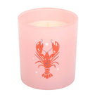Pink candle with a red lobster design on a white background