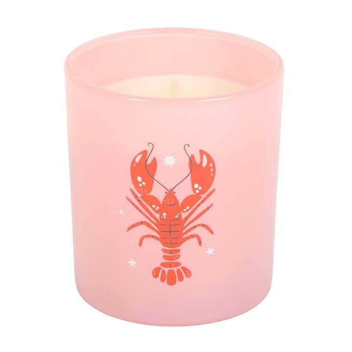 Pink candle with a red lobster design on a white background