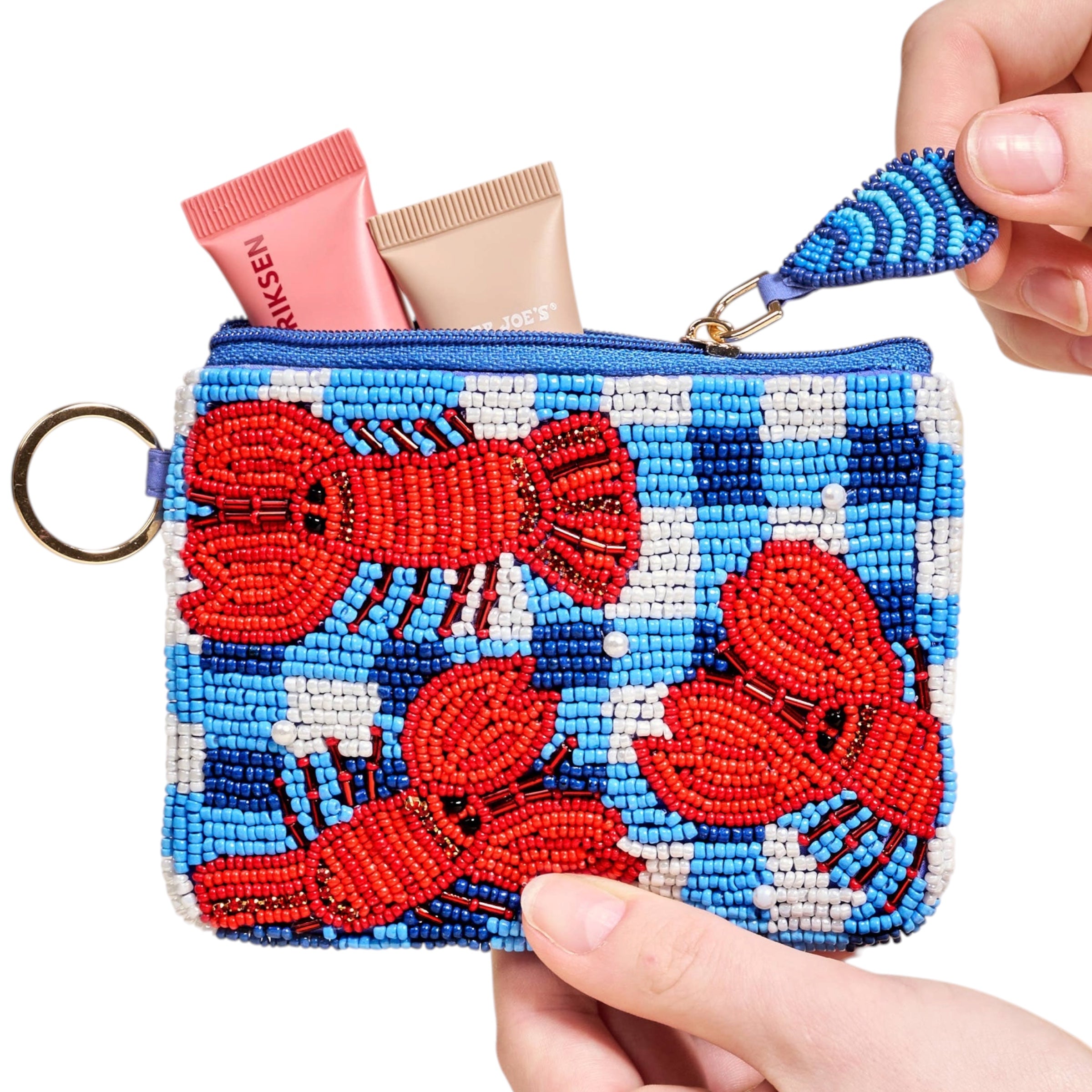 Beaded pouch with red lobster design held by a hand