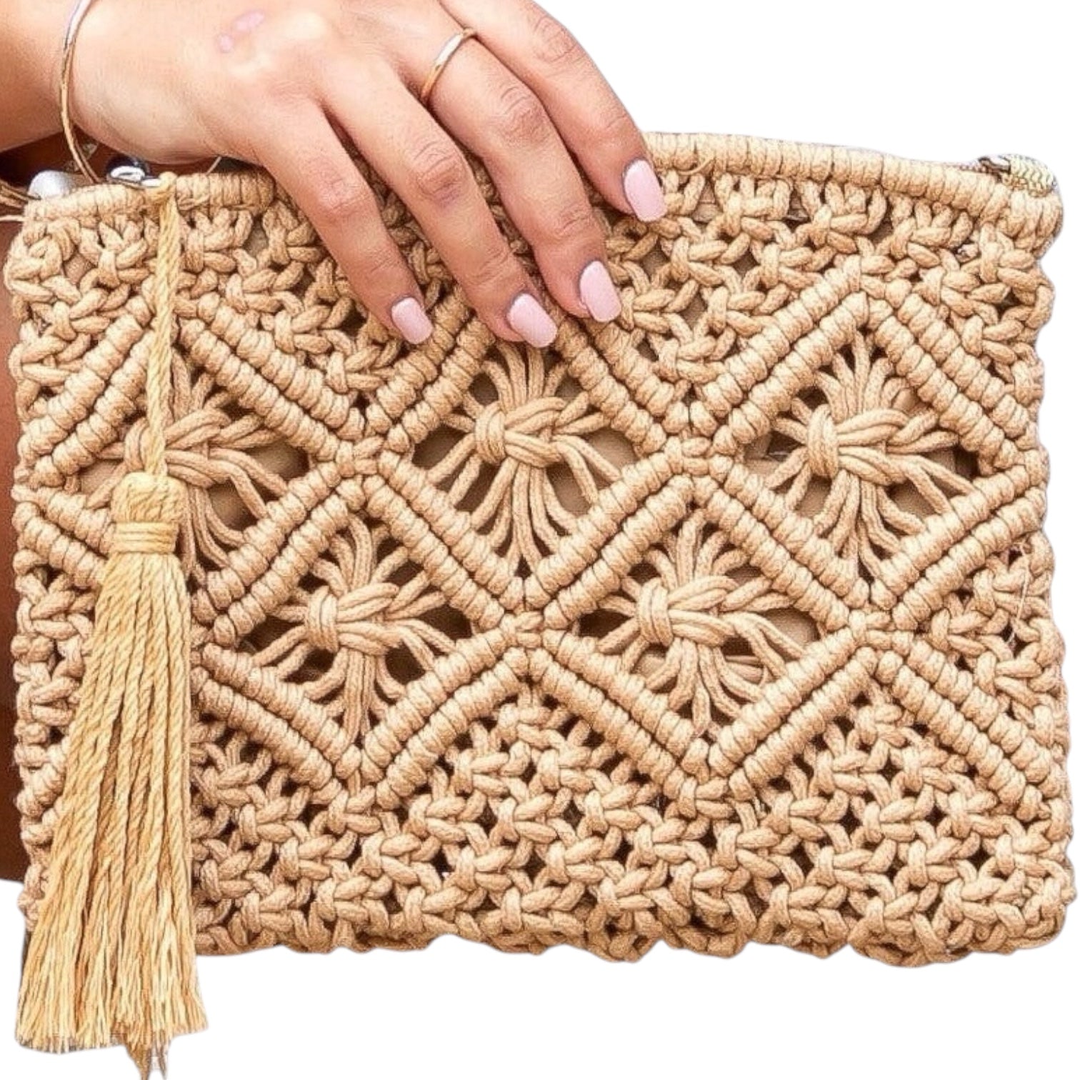 Woven clutch bag with a tassel held by a hand on a white background
