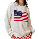 a woman wearing an american flag sweater on a white background