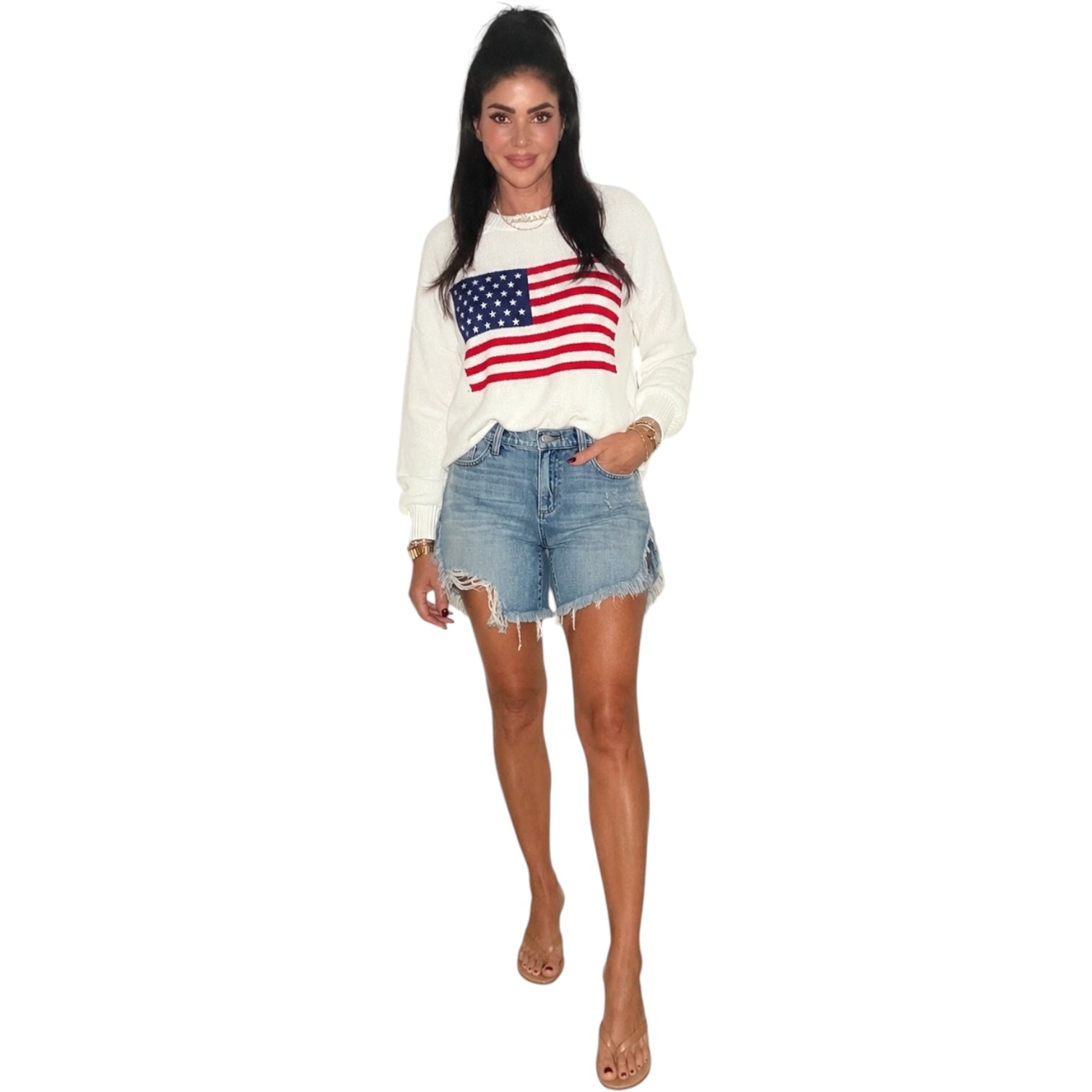 a woman wearing an american flag sweater on a white background