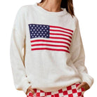a woman wearing an american flag sweater on a white background