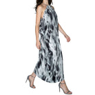 Woman wearing a black and white patterned dress on a white background