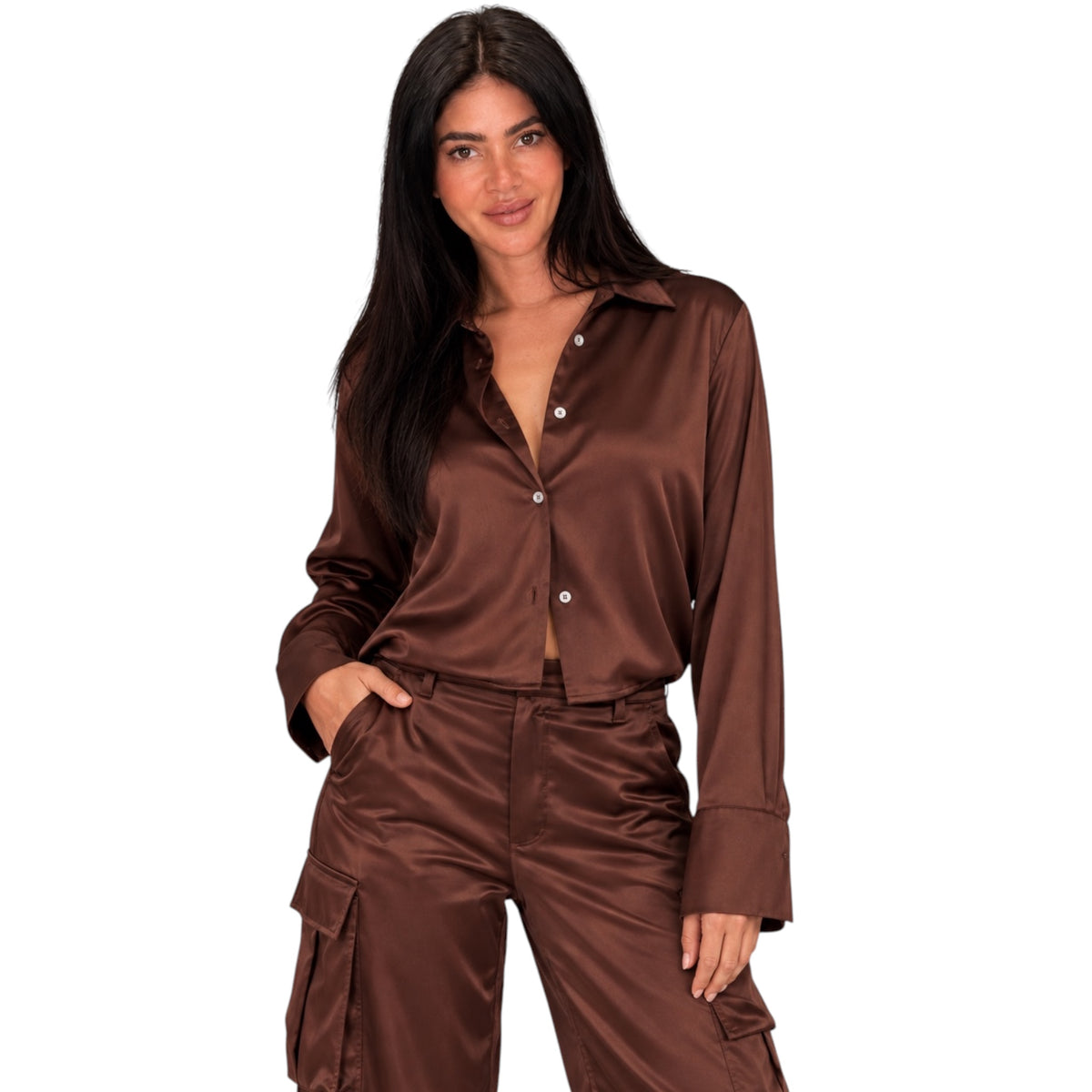 A woman modeling a matching brown satin button-up shirt and cargo pants set against a plain white background.