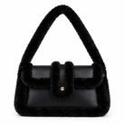 A black faux-fur trimmed shoulder bag with a smooth black leather front flap and a small gold-tone button detail, shown on a plain white background.