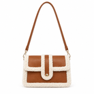 A structured shoulder bag with a brown faux-leather body and cream sherpa fleece trim, featuring a single brown shoulder strap and a gold-tone snap button closure.