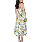 Woman wearing a colorful patterned dress on a white background