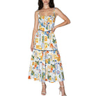 Woman wearing a colorful patterned dress on a white background