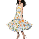Woman wearing a colorful patterned dress on a white background