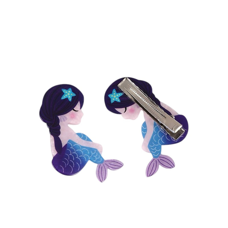 Mermaid-shaped hair clips with blue hair and purple tail on a white background