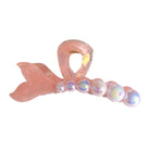 Pink mermaid tail hair clip with iridescent beads on a white background