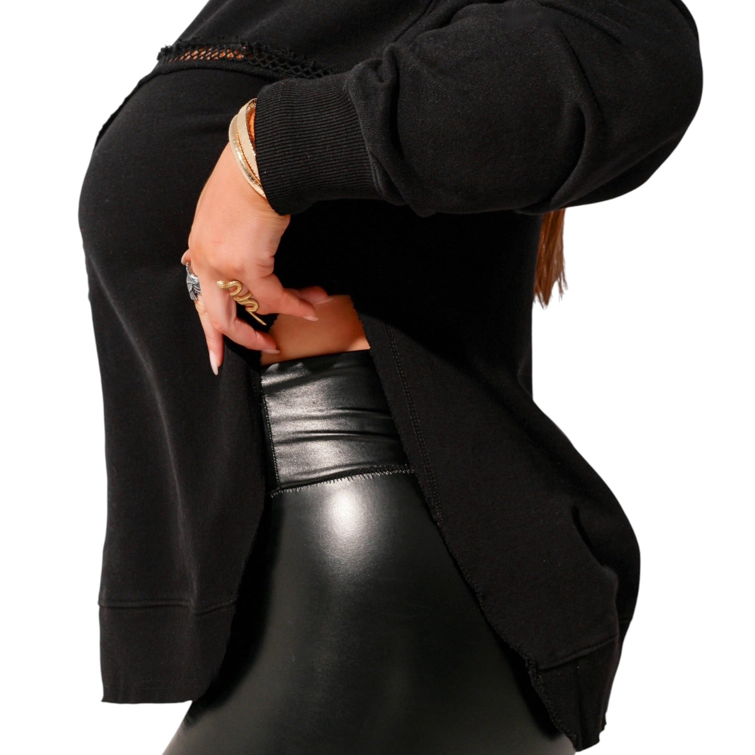 Person wearing a black jacket and black leather pants on a white background