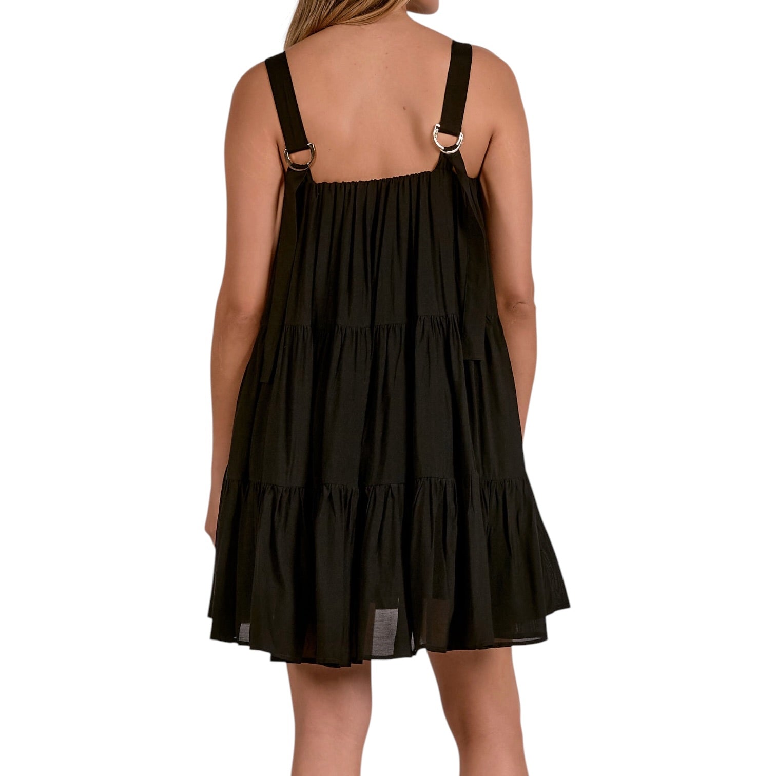 Black tiered dress with thin straps on a white background