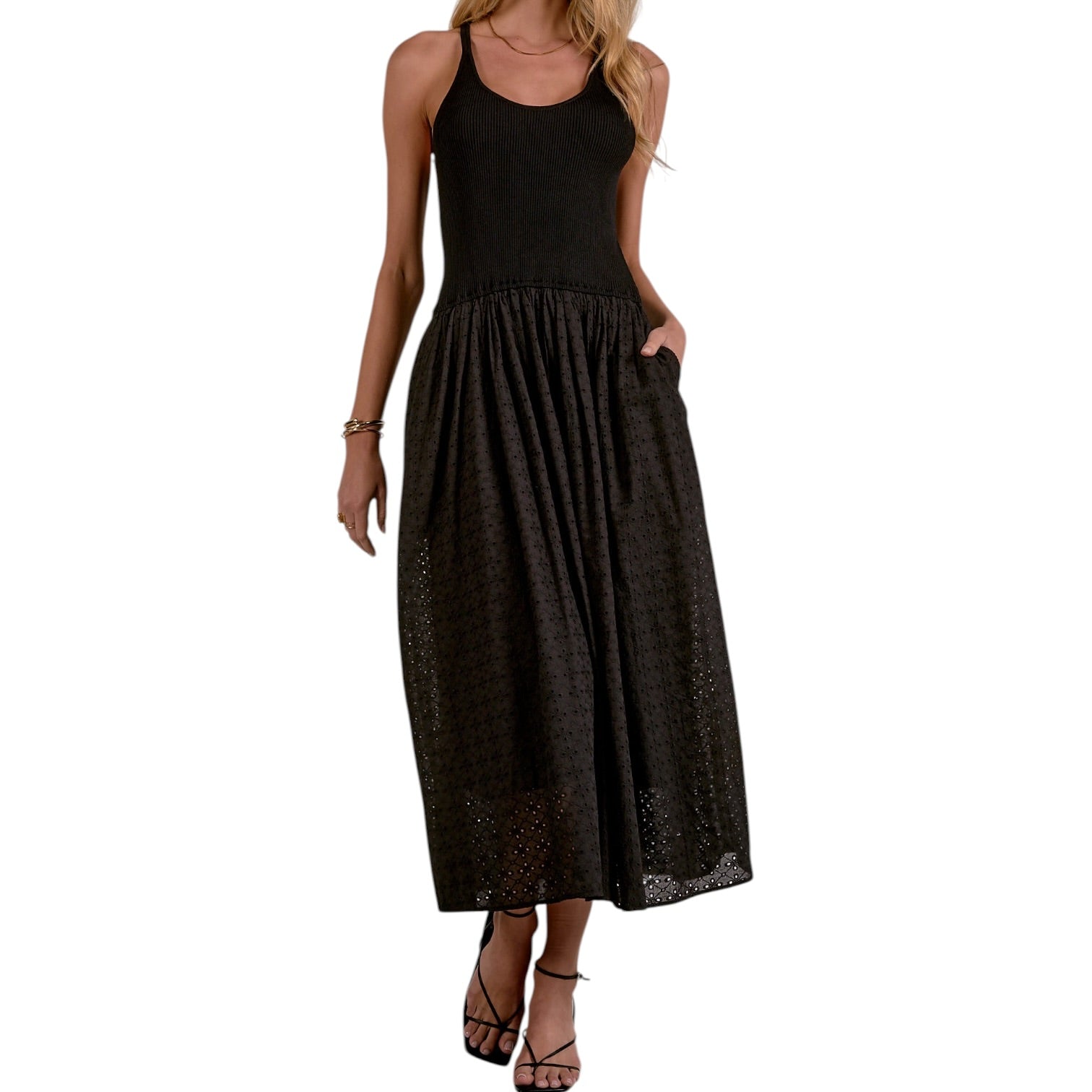 Black sleeveless top and black skirt worn by a model on a white background