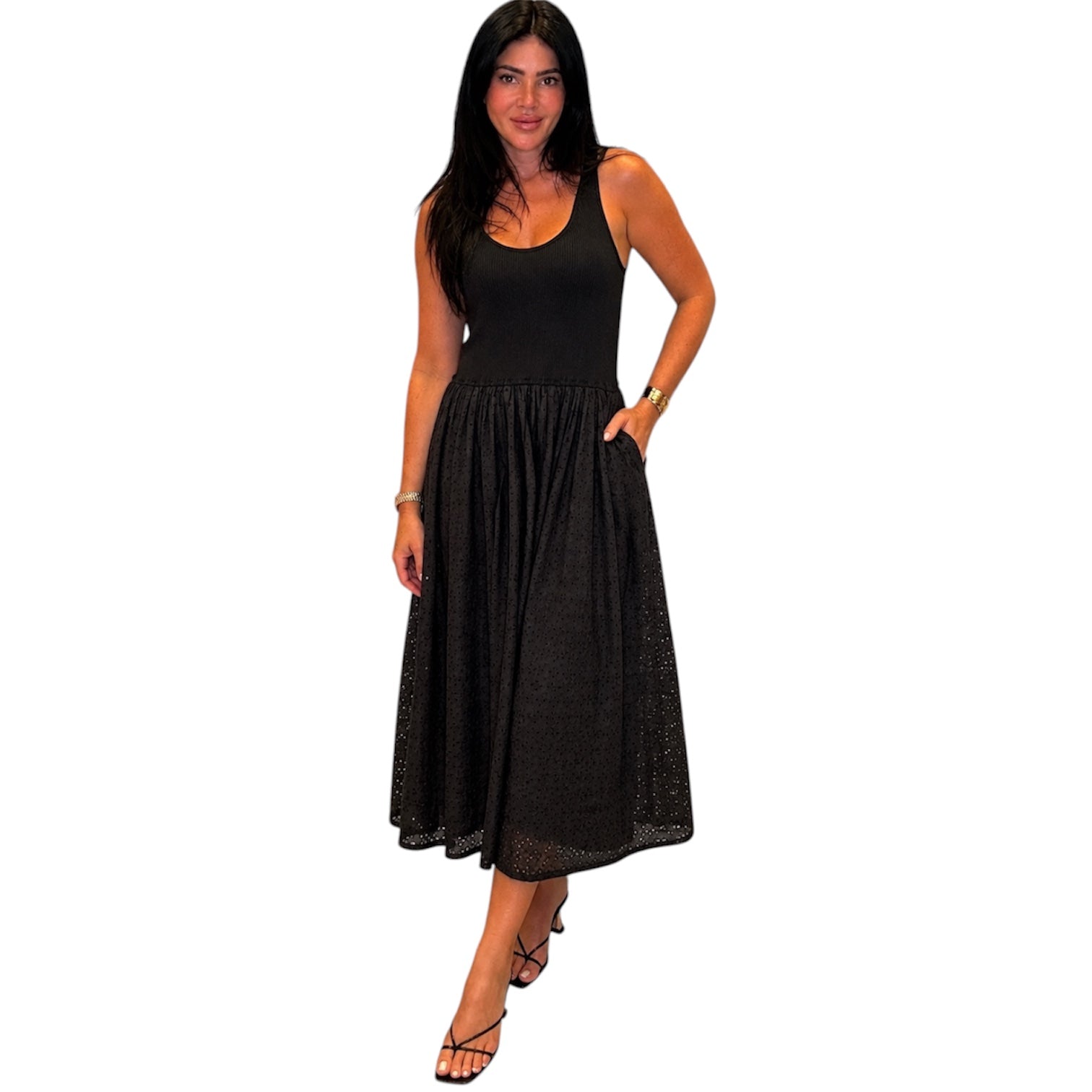 Woman wearing a black sleeveless dress on a white background