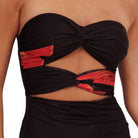 Black strapless top with red accents on a white background