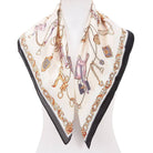 Decorative scarf with jewelry-themed design on a mannequin