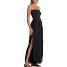 Black strapless jumpsuit with a high slit on a white background
