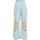Light blue pants with lace panels on a white background