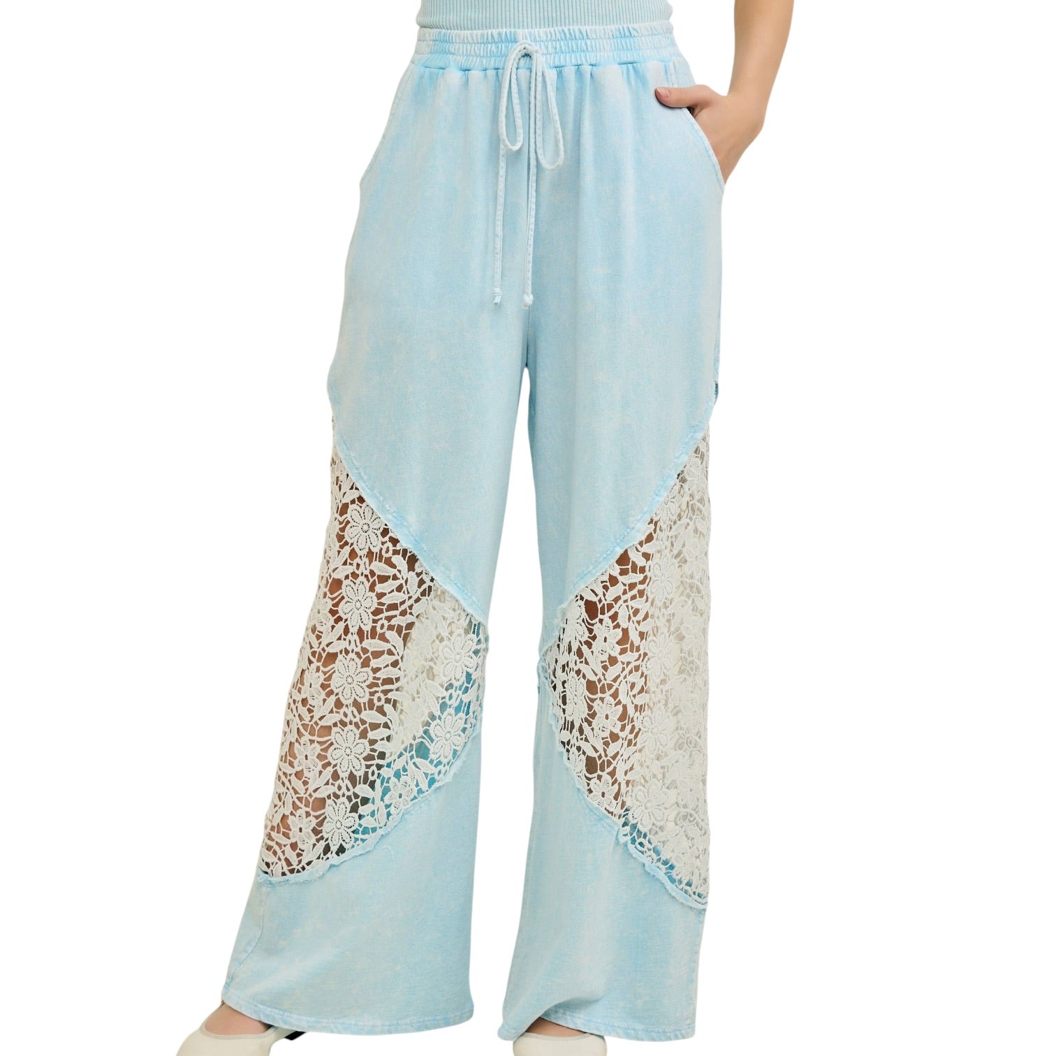 Light blue pants with lace detailing on a white background