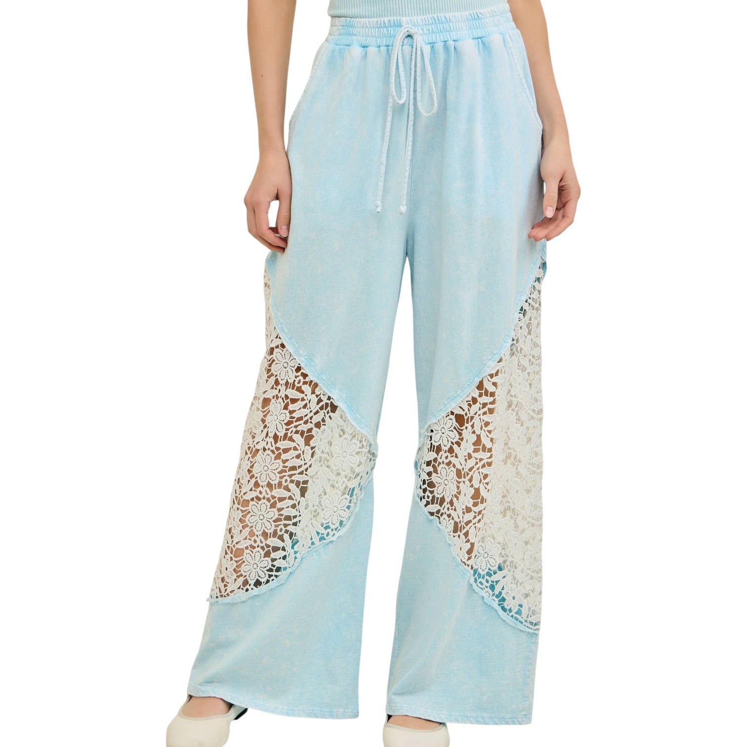 Light blue pants with lace detailing worn by a person on a white background