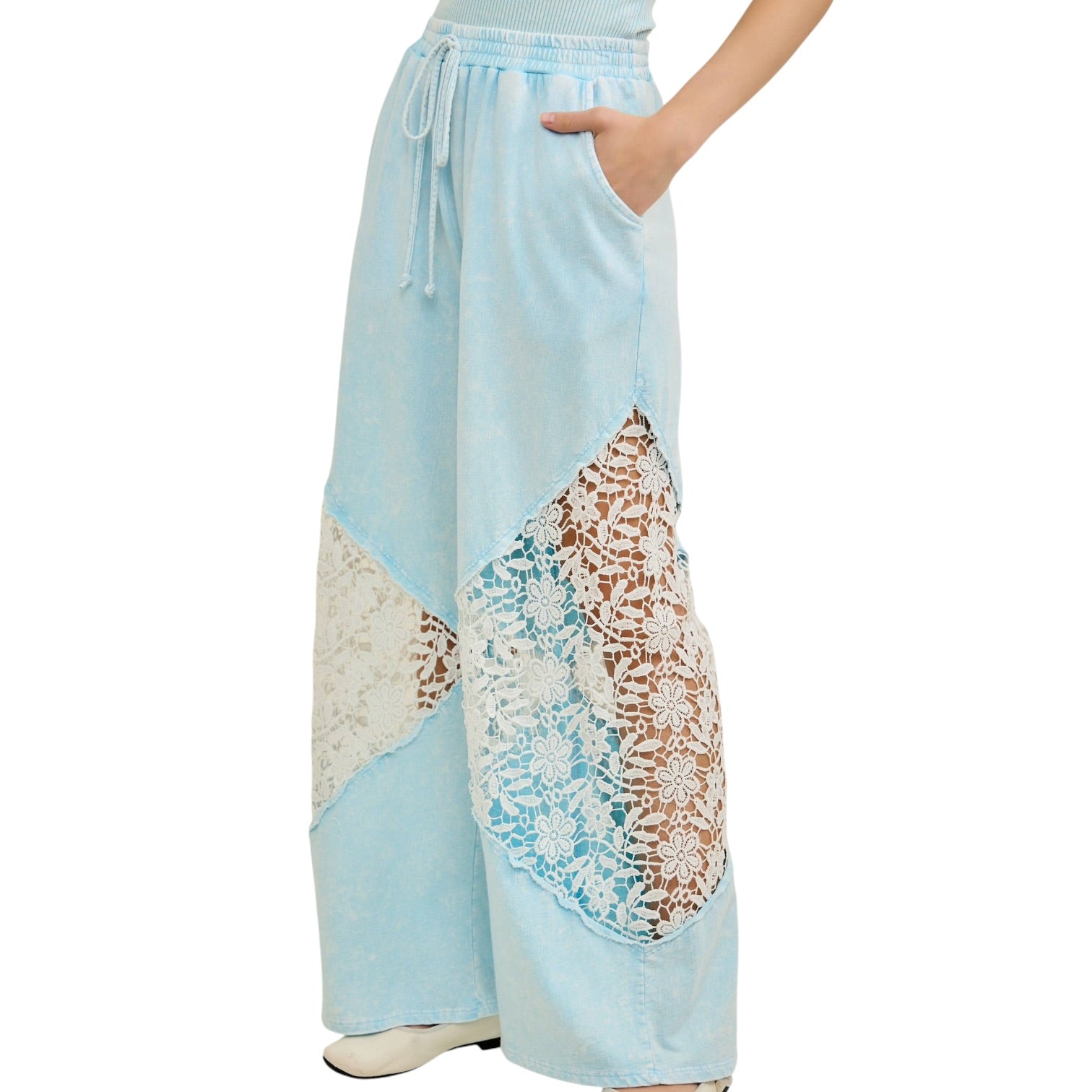 Light blue pants with lace detailing on a white background