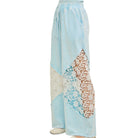 Light blue pants with a decorative pattern on a white background