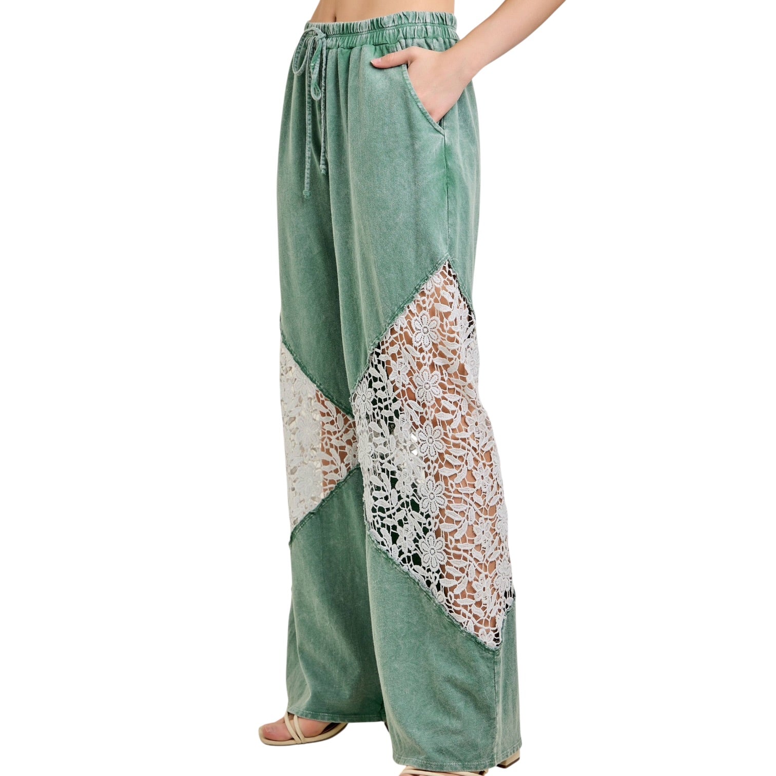 Green wide-leg pants with lace detailing on a white background