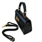 Black handbag with gold accents on a white background