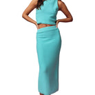 Teal two-piece outfit with top and skirt on a white background