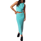 Turquoise knit top and skirt set on a white background