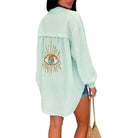 Mint long-sleeve top with eye design on a white background
