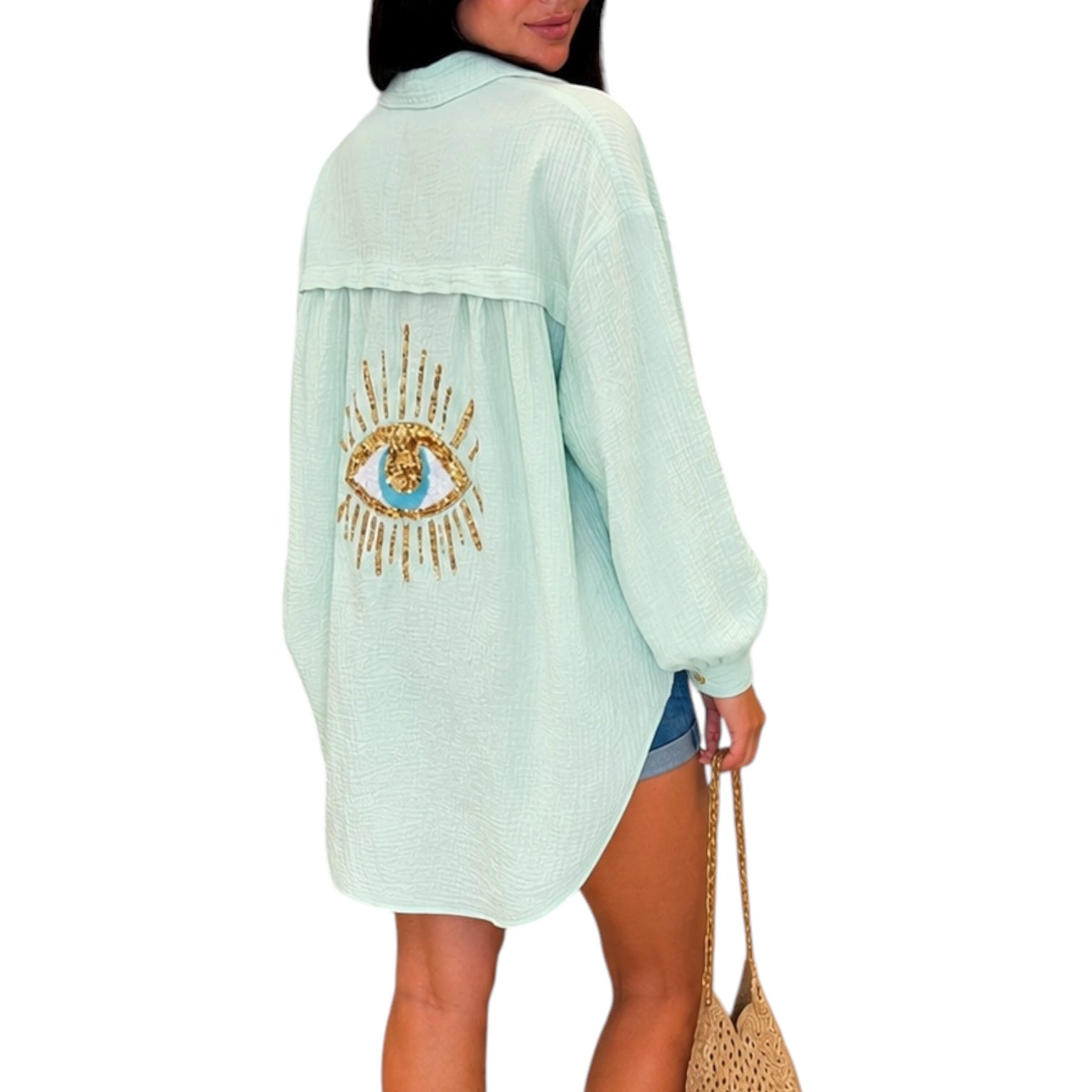 Mint long-sleeve top with eye design on a white background