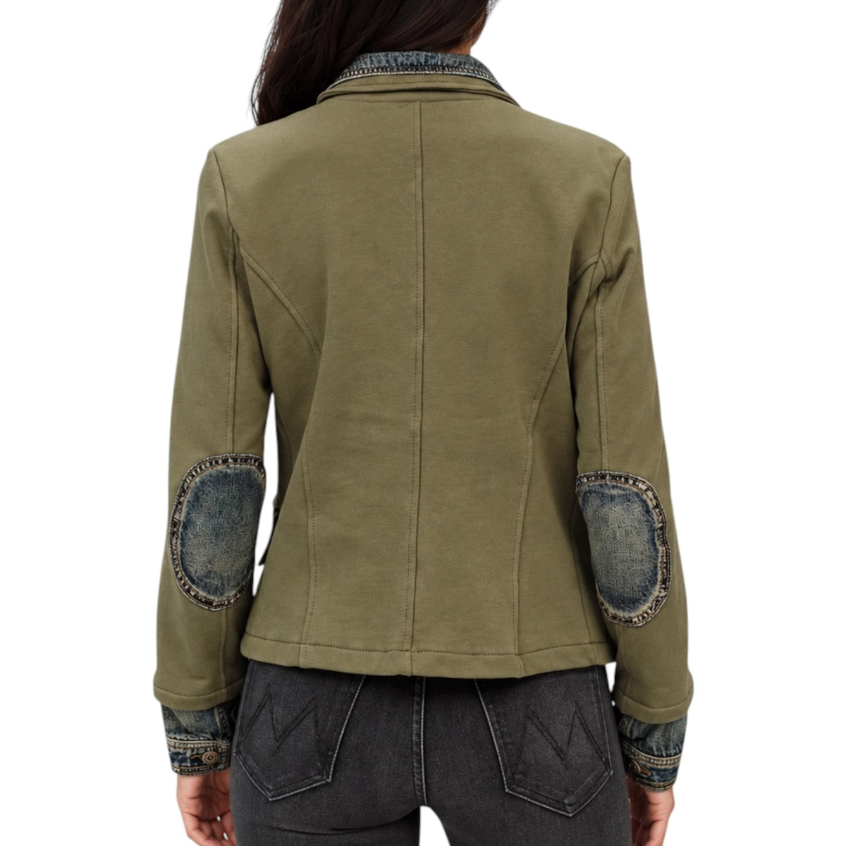 A woman viewed from the back wearing an olive green jacket with distressed denim elbow patches and matching denim trim on the collar and cuffs, paired with dark gray jeans against a plain white background.