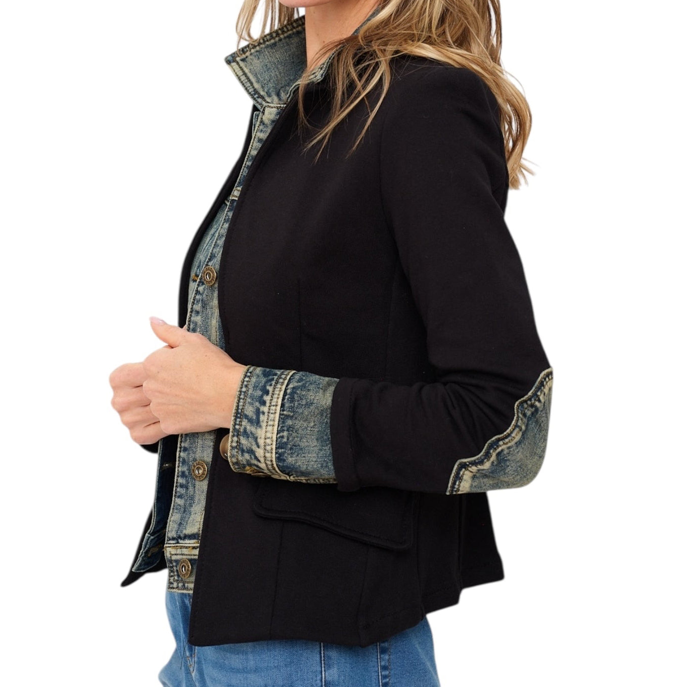 Black jacket with denim sleeves worn by a person on a white background