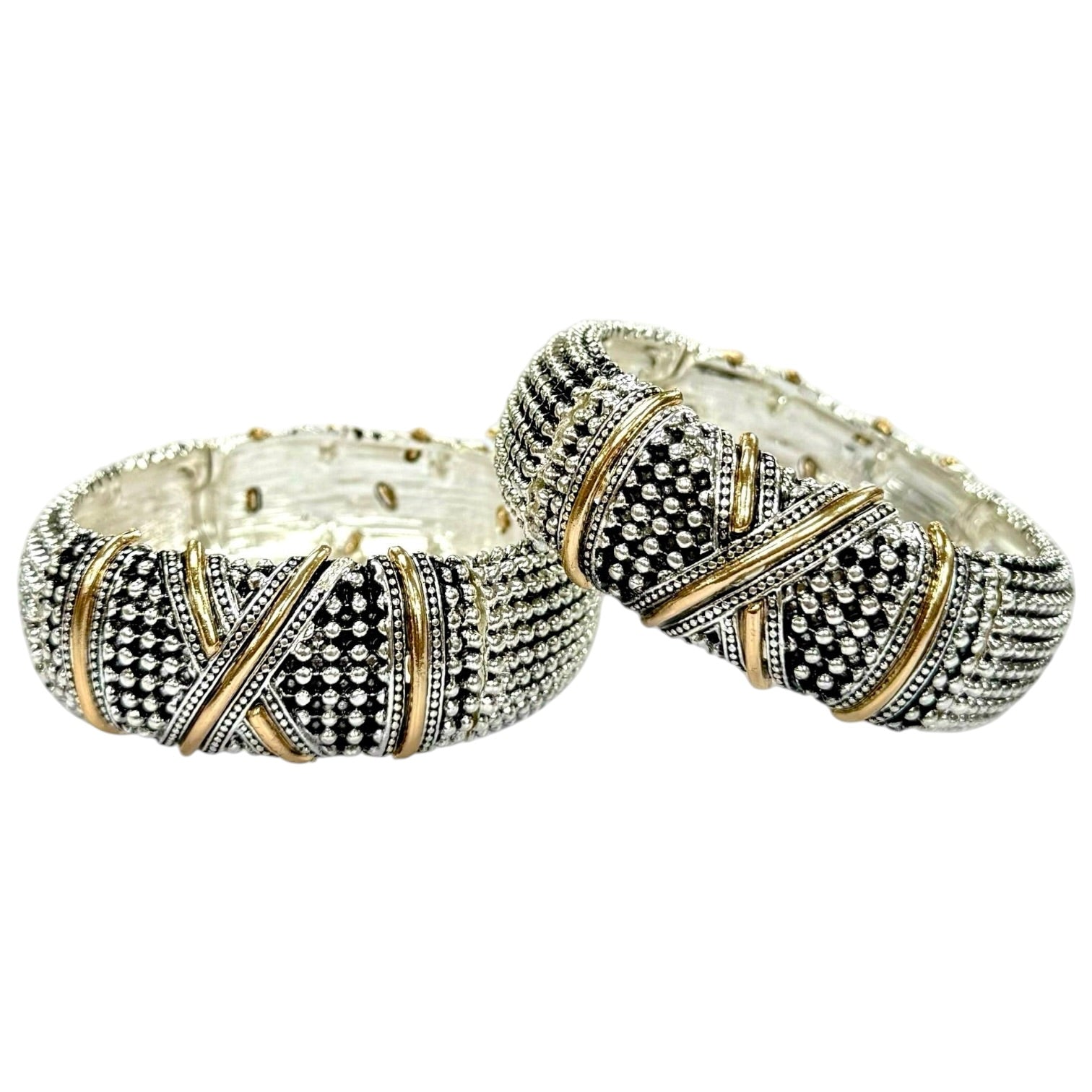 Two silver-toned bangles with black and gold pavé detailing, displayed on a clean white background.