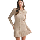 Woman wearing a beige ribbed dress with buttons on a white background