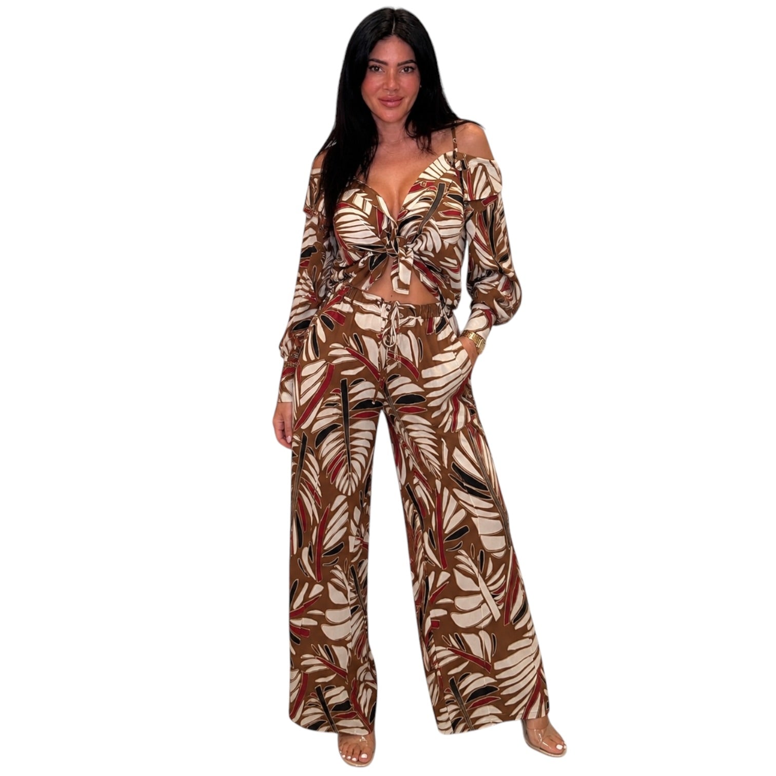 a woman wearing a palm printed two piece pant set on white background