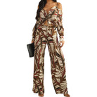 a woman wearing a palm printed two piece pant set on white background