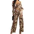 a woman wearing a palm printed two piece pant set on white background