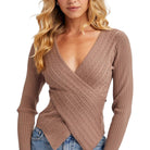 Woman wearing a brown ribbed sweater on a white background