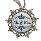 Decorative ornament with 'Mr. & Mrs.' text on a wooden background